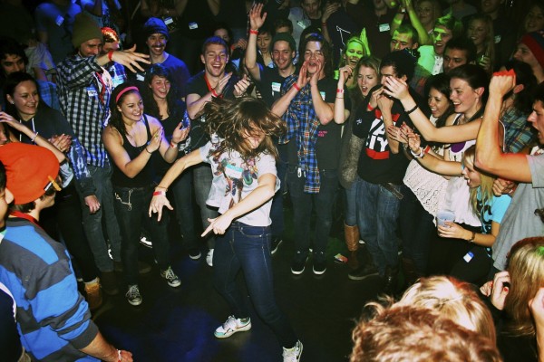 People partying and dancing in a circle