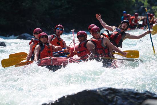 People in white water raft around whistler