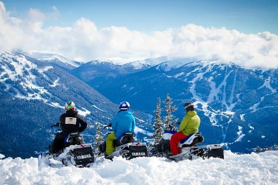 Snowmobiles overlooking Whistler blackcomb