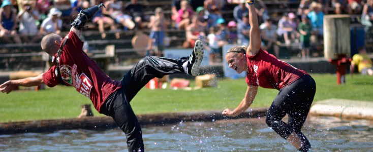 Man falling off a log in a competition