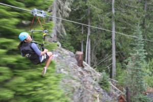 A person speeding down a zipline