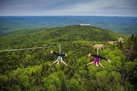 A tandem zipline above a valley