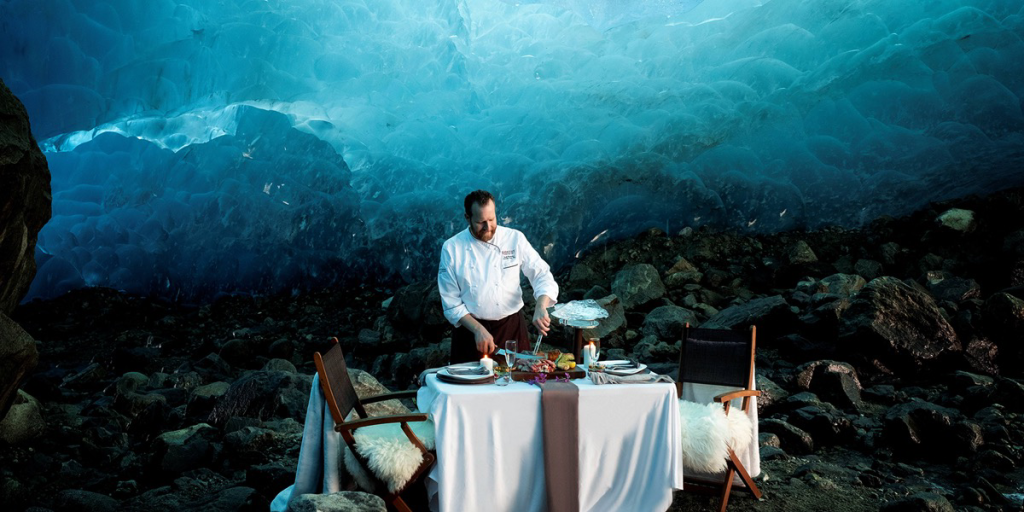 Chef setting a table in a glacier