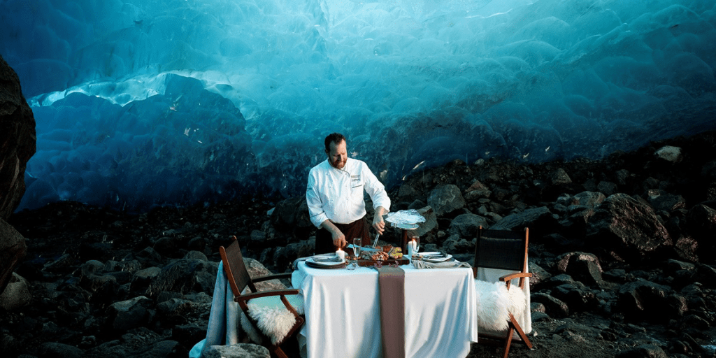 Chef setting a table in a glacier