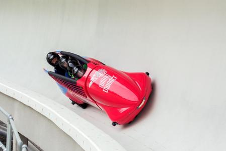Two people at the sliding centre in a bobsled