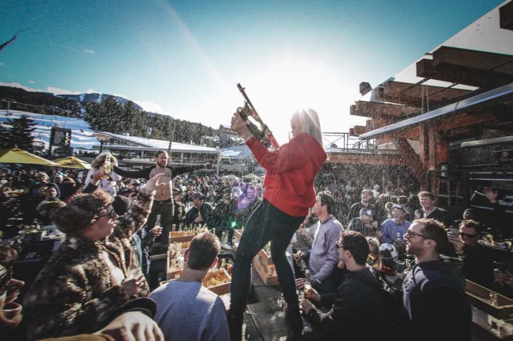 Longhorn pub patio. Woman spraying champagne on the crowd