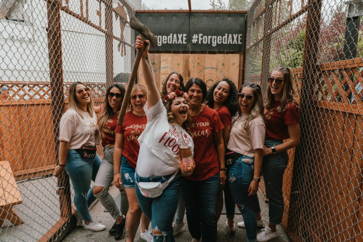 a group of people standing in front of a fence