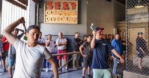 A man getting ready to toss an axe