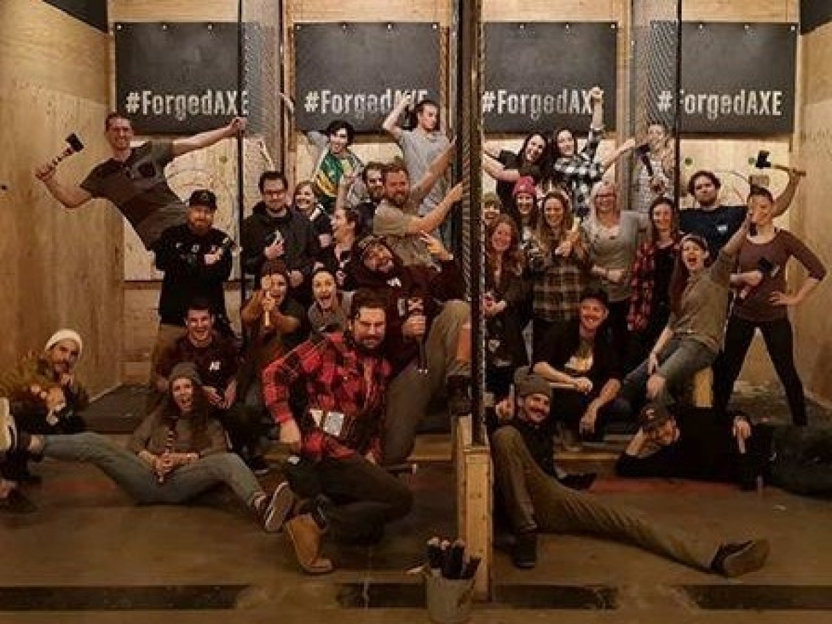A group of people posing for a picture during the axe throwing league