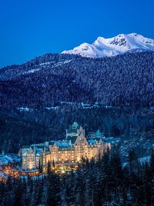 a snow covered mountain, hotel at the base