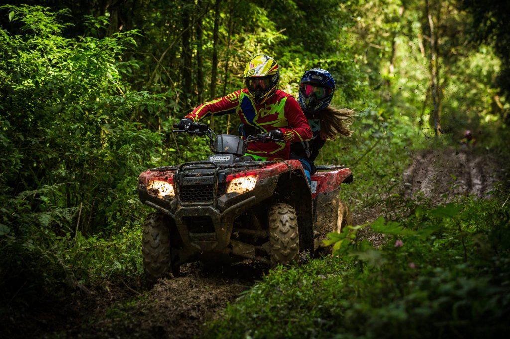 man and woman on atv in Whistler off road muddy
